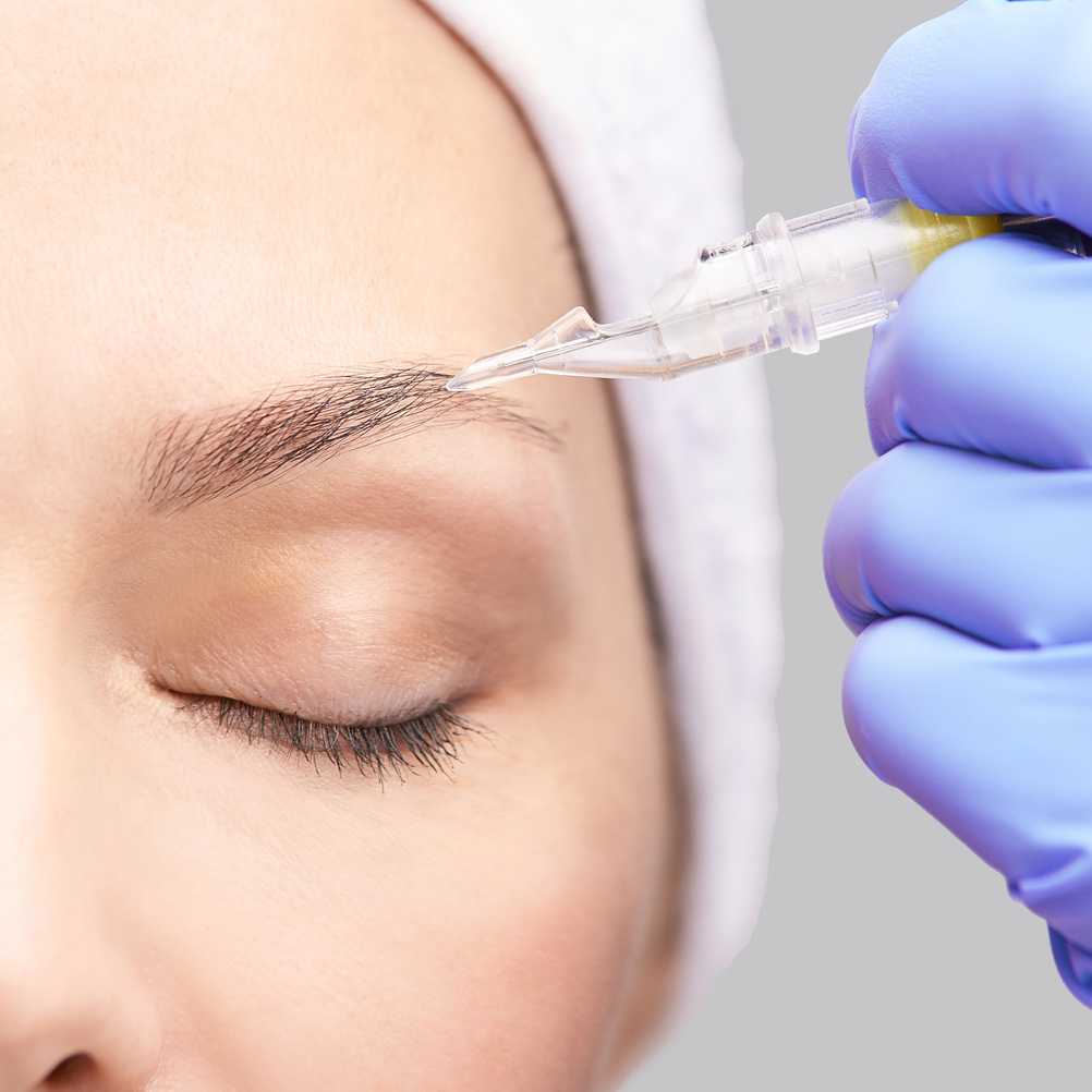 Woman Getting an Eyebrow Tattoo  